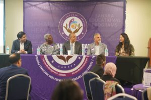 Our illuminating discussion panel featuring five prominent community leaders from left to right: Dr. Hamza Rana, President APPNA DMV Chapter; Dr. Gloria Addo-Ayensu, Public Health Strategist & Academic; Dr. Babur Lateef, Chair of PWCS Board; Dr. Zaheer Shah, Sahara Board of Directors; Spojmie Nasiri JD, Immigration Attorney