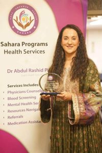 Sister Spojme Nasiri accepts the Community Champion Award for her outstanding work for underserved communities in the MDV area. Sister Spojme is an immigration attorney and advocate, and also was part of this event's discussion panel.